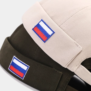 Beige and olive cotton Miki hats with Russian flag embroidery detail on white background