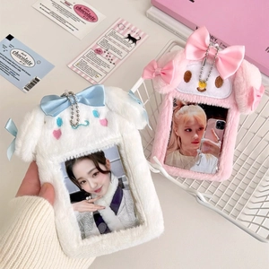 Close-up of plush rabbit photocard holders with cute bow ties and soft texture details