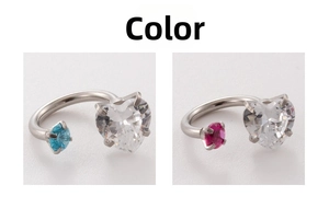 Macro detail of horseshoe ear studs featuring heart and round cubic zirconia stones
