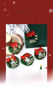 Close-up of five mini Christmas wreaths with pine needles, red bows and gold bells