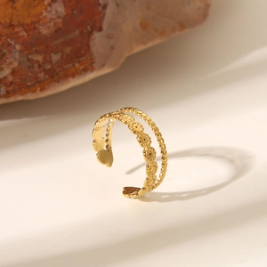 Detailed close-up of a vintage golden double-layer crown ring with floral patterns