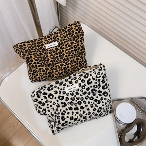 Detail view of retro leopard print canvas makeup bags with zippers and simple wish tags