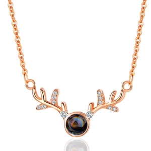 Rose gold elk antler projection necklace with sparkling diamonds and a round center stone