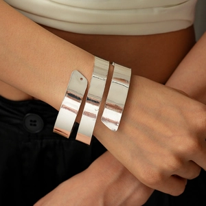 Close-up of a silver wide multi-layer spiral cuff bracelet with polished metal finish