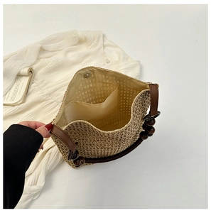 Detail view of woven beach bag interior featuring beige lining and a small pocket