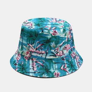 Detailed pattern of pink flamingo and green palm leaf prints on a canvas bucket hat