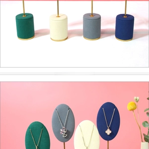 Close-up of wooden necklace display stand with premium velvet finish and metal rod support