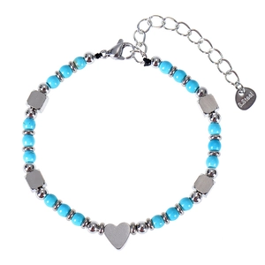 Detail of blue turquoise beaded bracelet with heart pendant and stainless steel clasp