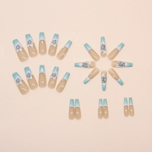 Macro detail of French blue gradient press-on nails with floral art and pearls