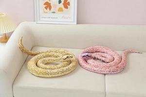 Detailed realistic snake plush toy with scale patterns on a cozy beige sofa