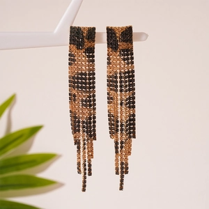 Close-up of leopard print tassel earrings with sparkling rhinestones on display