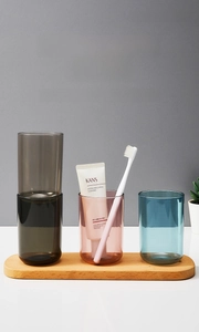 Three transparent luxury mouthwash cups in smoke gray, amber pink, and ocean blue finish
