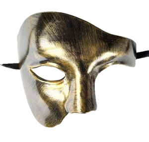Macro view of vintage-style phantom masquerade mask with antique gold and black finish