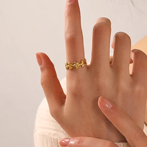 18K gold plated stainless steel leaf ring shown on model in warm natural light