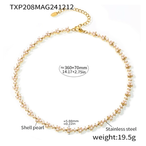 Macro view of gold PVD stainless steel chain with delicate white shell pearls