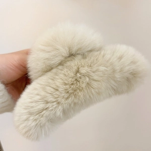 Detail of soft cream faux rabbit fur claw clip showing fluffy texture and large grip