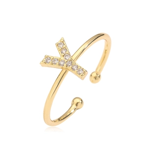 Macro detail of gold letter Y open ring featuring sparkling cubic zirconia stones