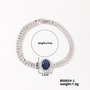 Detail showing 17cm silver bracelet with blue oval stone and dual-row diamond accents