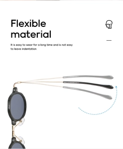 Detailopname van flexibele metalen pootjes op zwarte ronde brillen met elasticiteit