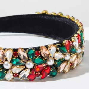 Macro shot of baroque headband featuring colorful crystals and pearls on black velvet