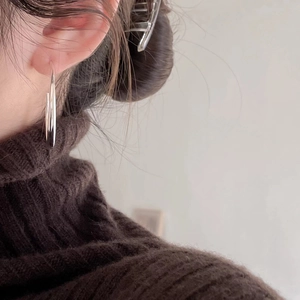 Elegant 925 sterling silver curved hook earrings worn on model for a minimalist look