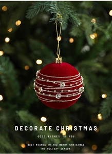 Close-up of 8cm burgundy velvet Christmas ball with gold sequins and beaded star decorations