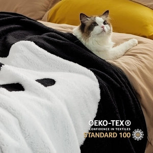 Detail of plush Halloween ghost blanket with OEKO-TEX certified flannel fabric and cat