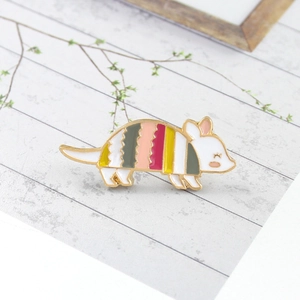 Cute cartoon armadillo enamel pin with colorful stripes and gold metal lines