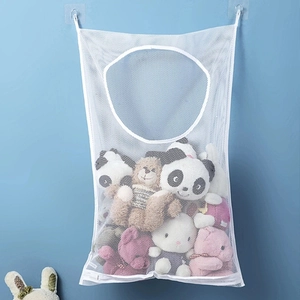 White mesh hanging storage bag for laundry and plush toys on a light blue bathroom wall