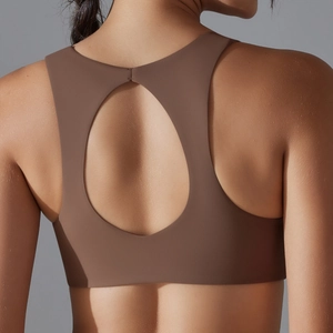 Detail of dark brown sports bra with oval back cutout and wide elastic straps