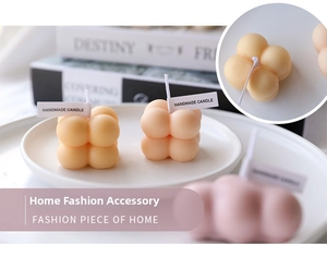 Detailed view of bubble aromatherapy candles with handmade labels in a cozy home setting
