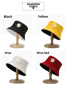 Four colors of cotton daisy bucket hats including black, yellow, beige and burgundy