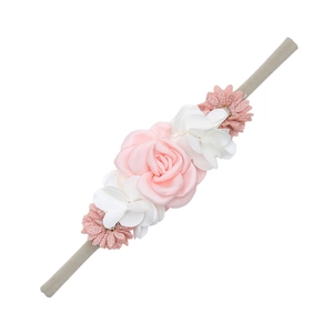 Detailed view of handmade fabric floral headband with pink roses and nylon elastic band
