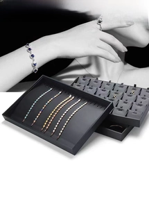 Deep grey PU leather jewelry tray featuring multiple ring slots and bracelet display sections