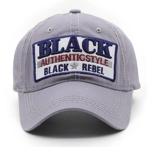 Detailed view of grey twill cotton baseball cap with Black Rebel embroidery and patches
