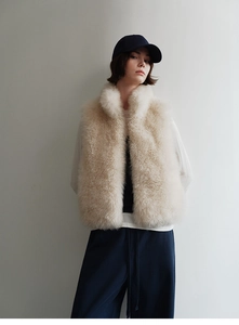 Full body shot of a plush cream faux fox fur vest showing soft texture and standing collar