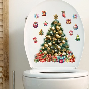 Detail of Christmas tree wall sticker with gifts and bells on white ceramic surface