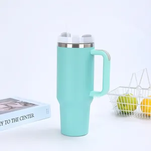 Close-up of a mint blue 40oz stainless steel insulated tumbler with a handle and straw