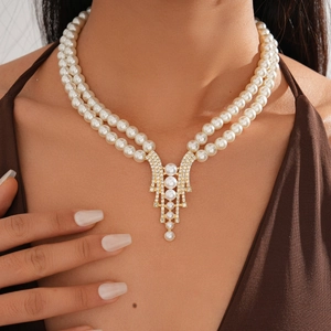 Close-up of double layer faux pearl necklace with gold diamond geometric pendant on model