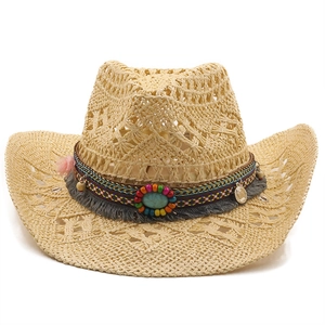 Detail of handmade straw cowboy hat with colorful beads, fringe, and turquoise stone