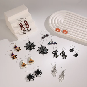 Halloween earring set featuring pumpkin, ghost, and black cat charms on white steps