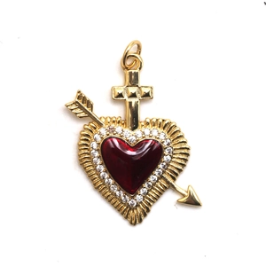 Detailed view of golden heart pendant with cross and arrow on white background