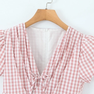 Pink and white plaid mini dress featuring a V-neckline with a sweet bow and bubble sleeves