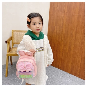 Pink girls backpack featuring shiny sequins, bunny ears, and a large bow design detail