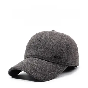 Detail of dark grey wool baseball cap showing hidden ear flaps and metal side logo