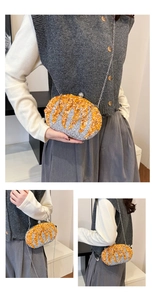 Detail of a sparkling orange and silver pumpkin evening bag with a metal chain strap