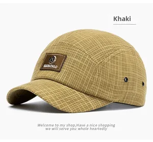 Close-up of khaki checkered 5-panel baseball cap with premium brown fabric brand patch