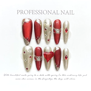 Detailed view of red cat-eye press-on nails with luxury heart-shaped rubies and rhinestones