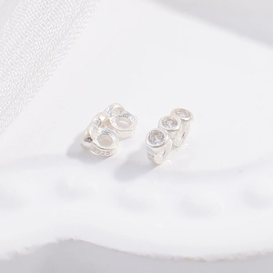 Macro shot of S925 sterling silver connector with three embedded clear zircon stones