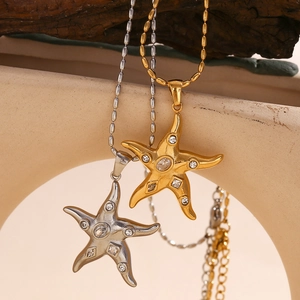 Close-up of starfish pendant with zircon stones on a beaded 18K gold plated chain